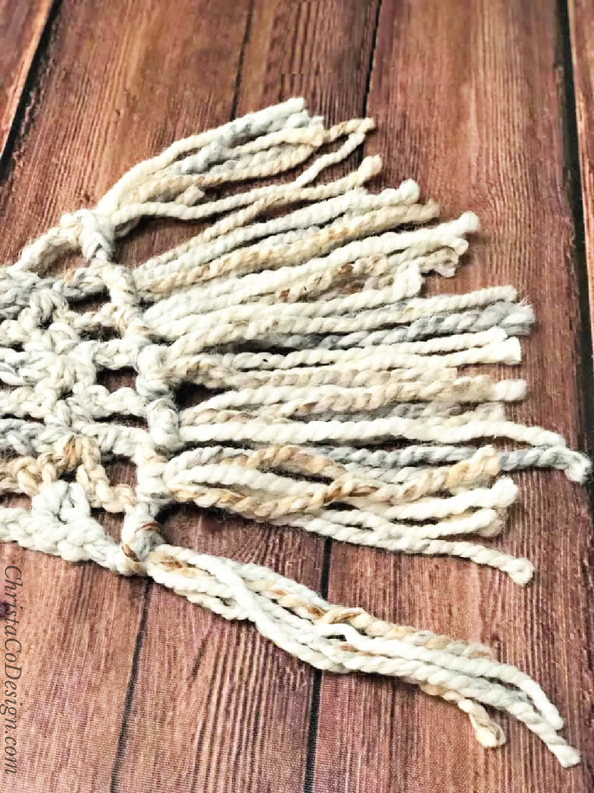 Last fringe attached to chunky crochet scarf.