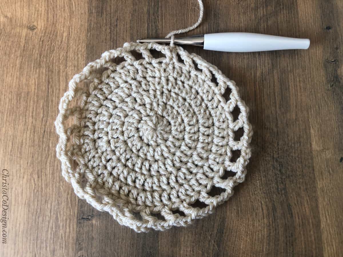 Cream circle with large mesh around outside.