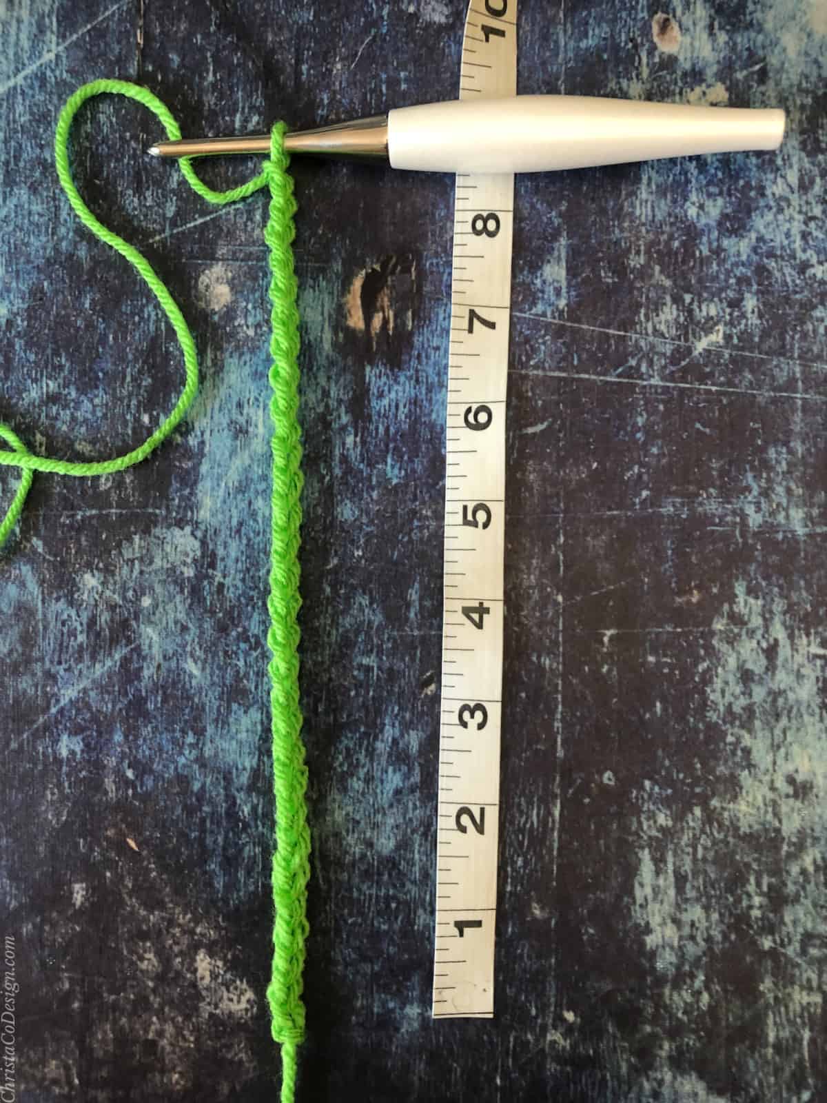 Green chain with measuring tape at 8."