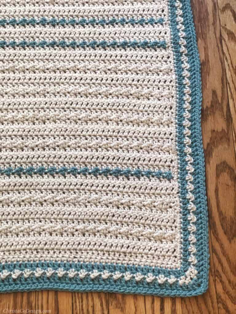 Contrasting border on blanket for baby up close.