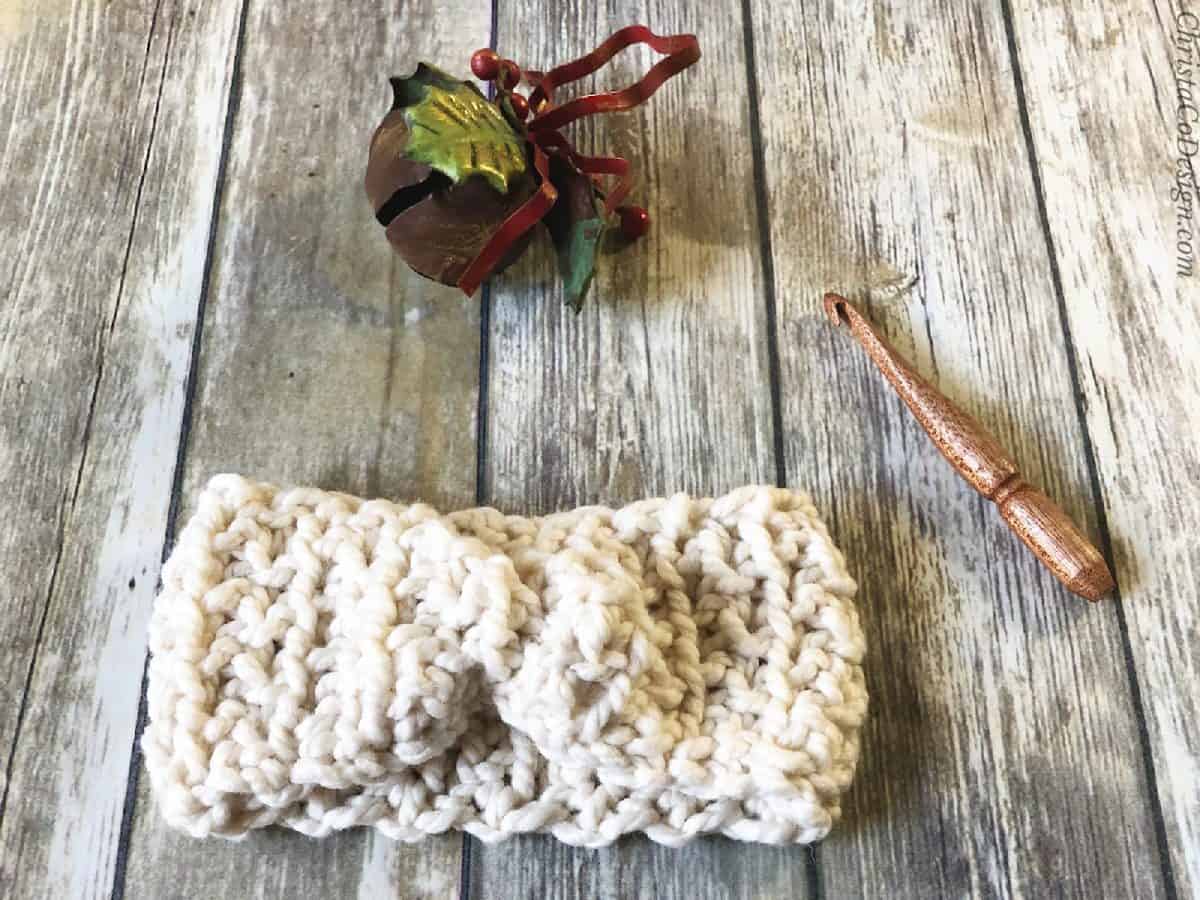 Crochet ear warmer pattern in chunky white yarn.