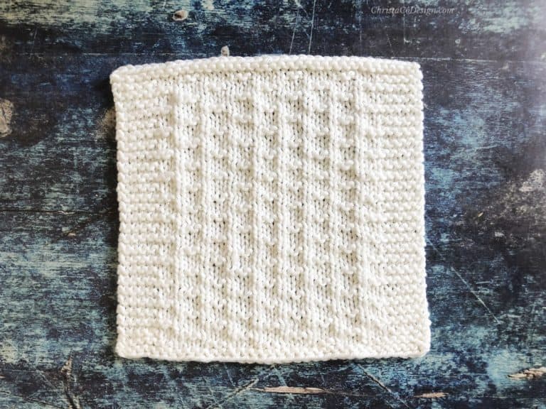 White blanket square knitting pattern on blue background.
