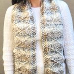 Chunky knit scarf with textured diamond pattern in beige.