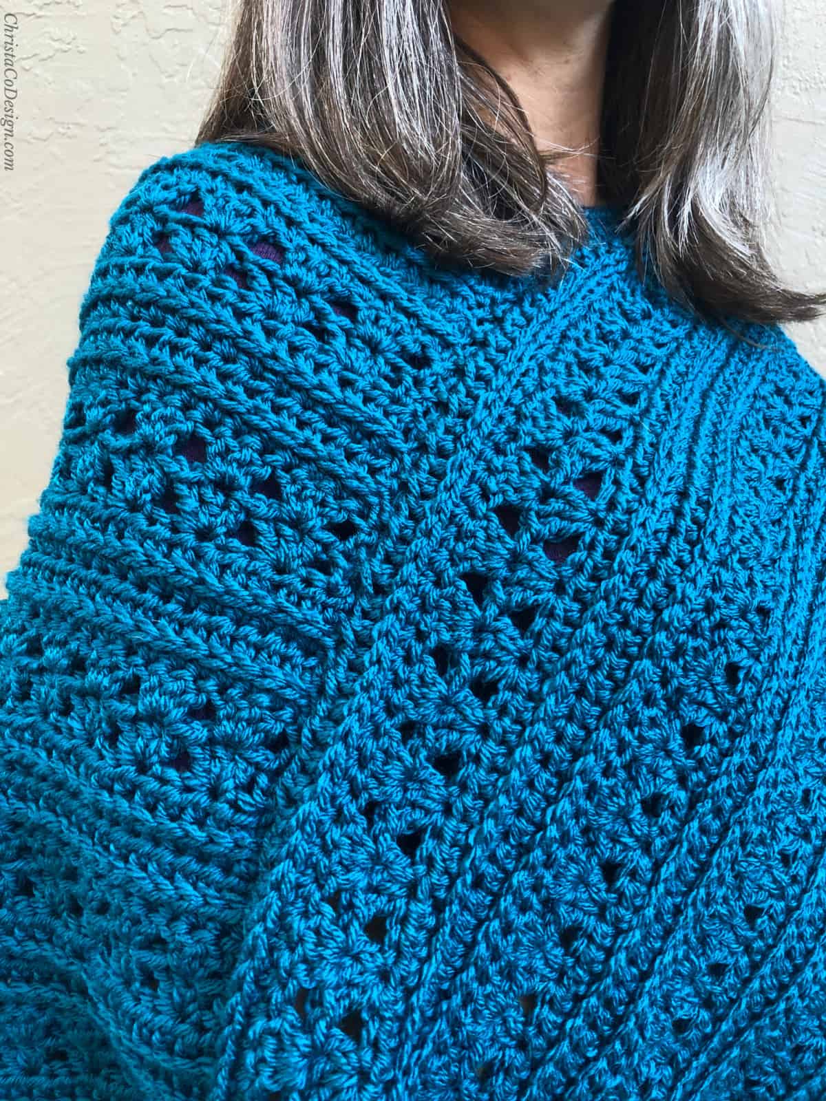 Close up of seam and texture on blue crochet poncho.