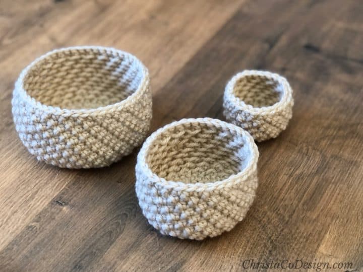 Textured sides of three round crochet baskets.