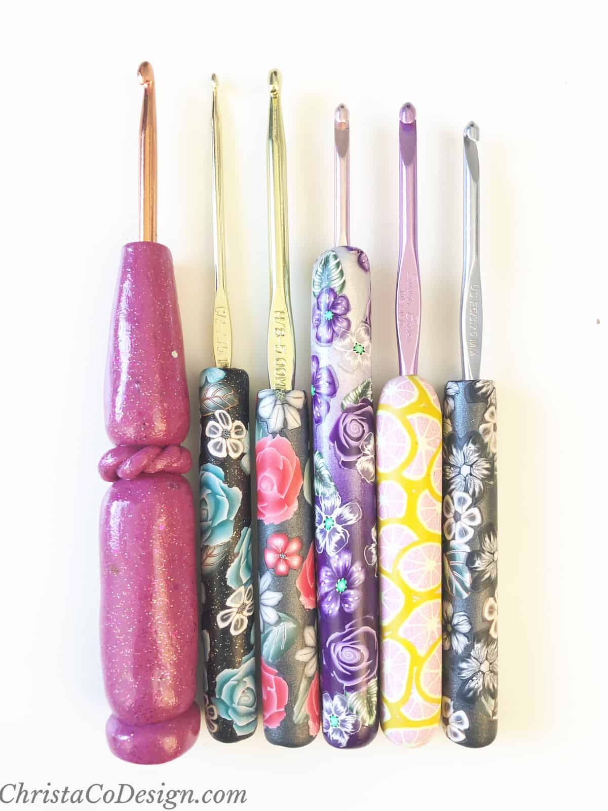 Set of crochet hooks with colorful and floral clay polymer handles added for comfort.