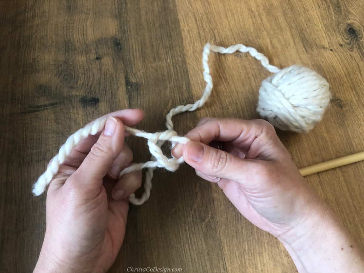 Pulling yarn through for crochet slip knot with fingers.