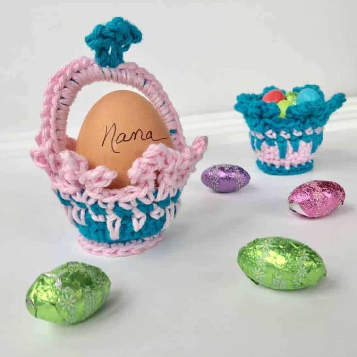Pink and blue crochet basket with a single egg inside.