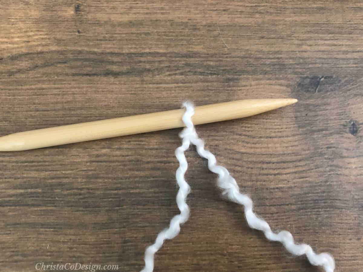 White slip knot on needle.