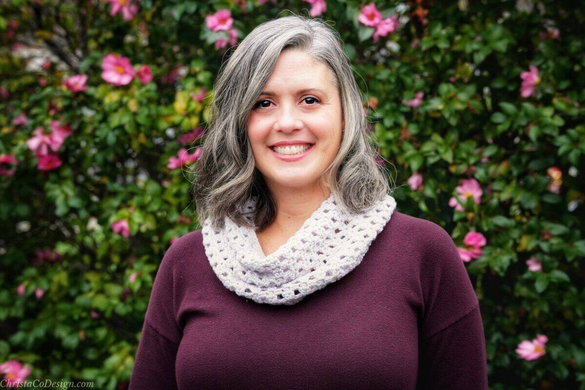 Woman smiling in white cowl.
