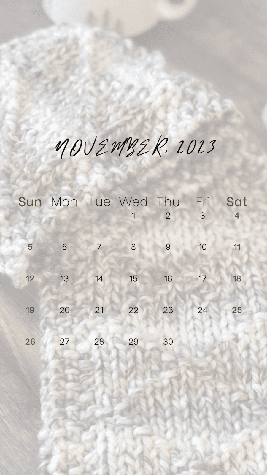 Nov 2023 calendar over cream and grey knit scarf.