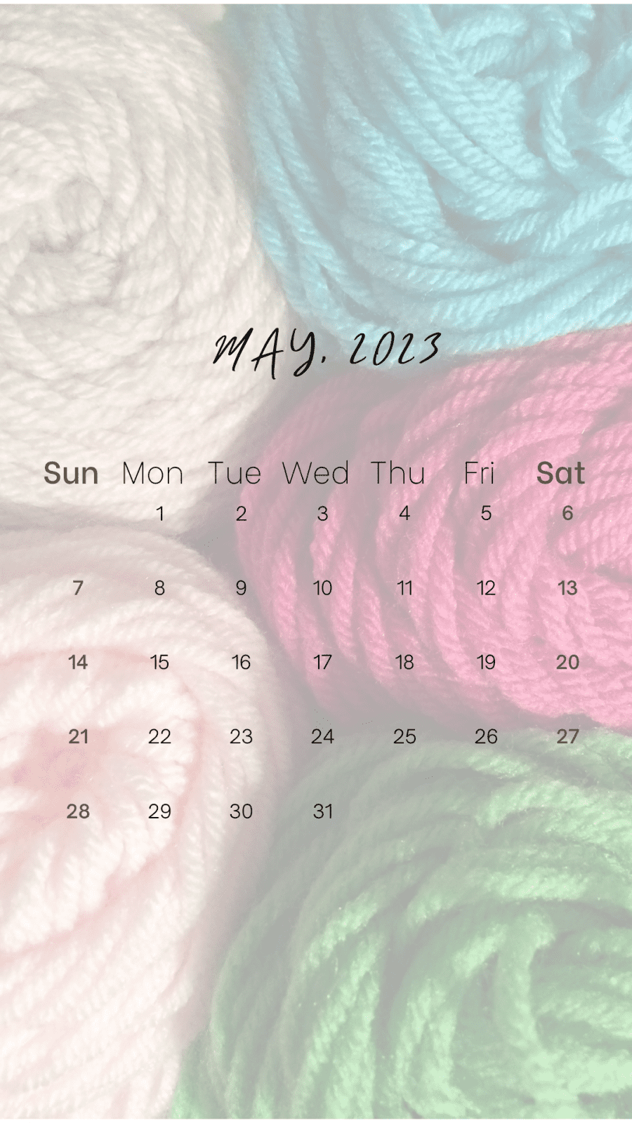 May 2023 calendar over pink and green yarn skeins.