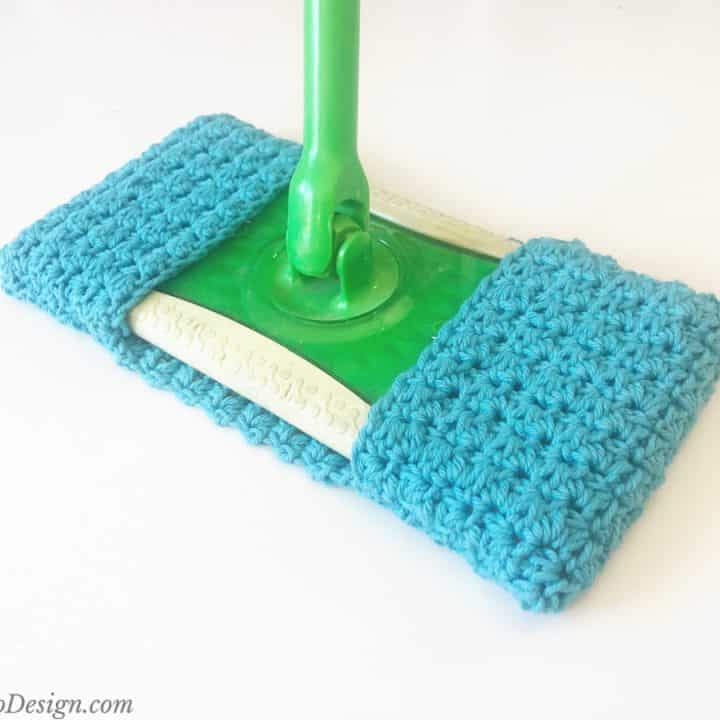 Blue crochet sweeper cover on green mop.