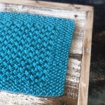 Seed stitch on border of blue knit dishcloth.