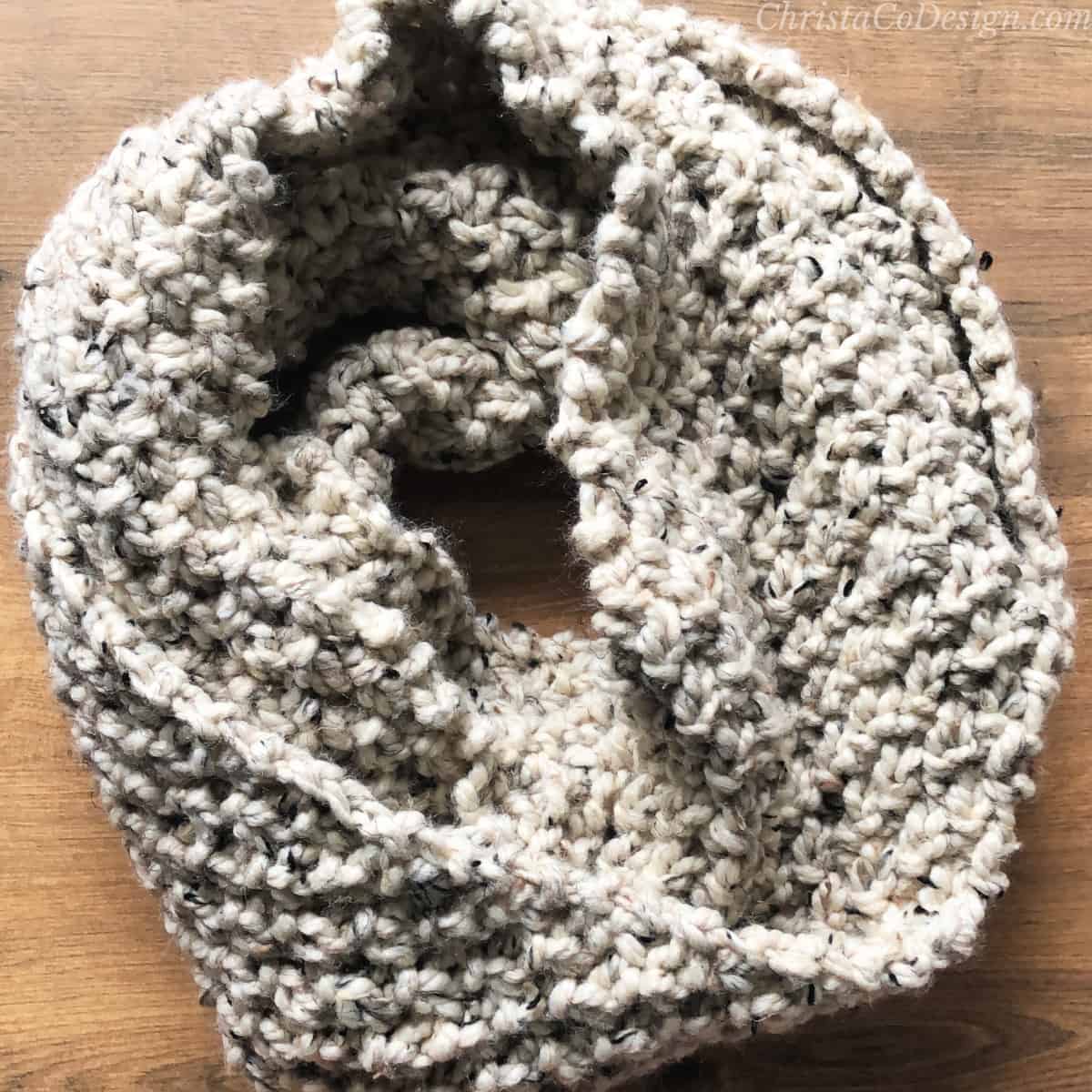 Textured snood wrapped in circle on table.