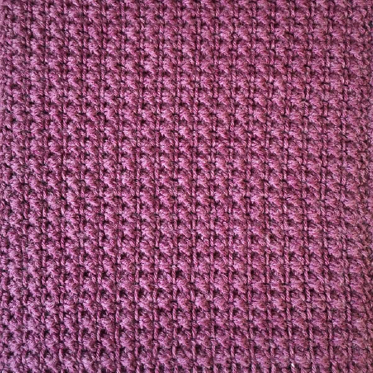 Dark pink purply blanket square in textured single crochet.