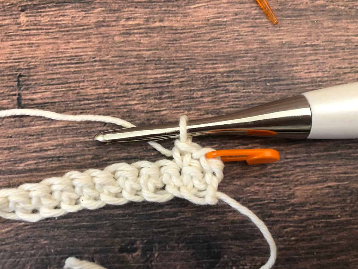 Single crochet in next stitch, chain one marked with orange stitch marker.