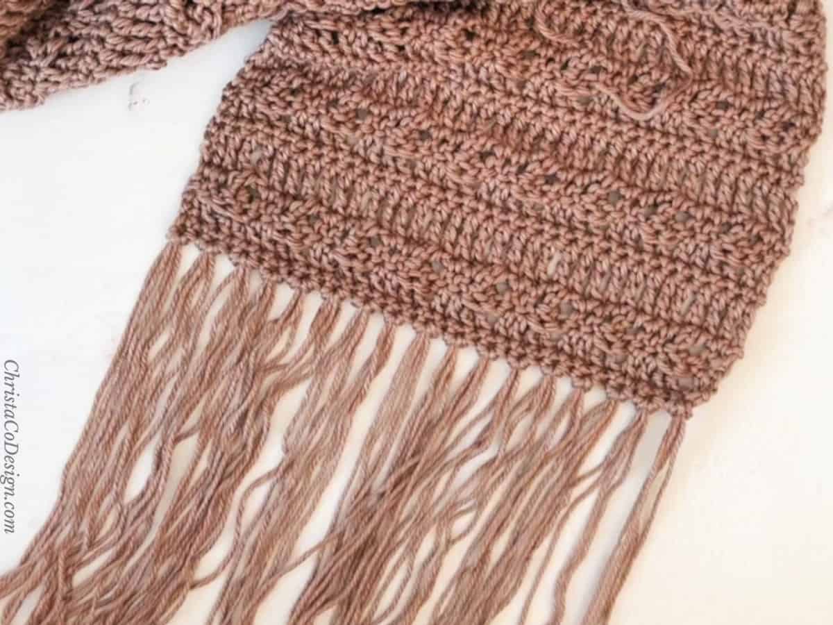 Single knot fringe in brown across bottom of scarf.