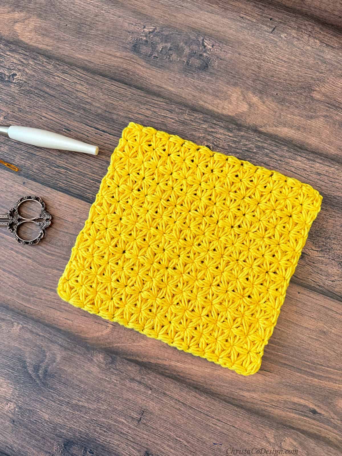 Yellow crochet square trivet.