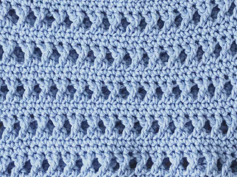 Treble x stitches between single crochet rows in blue.