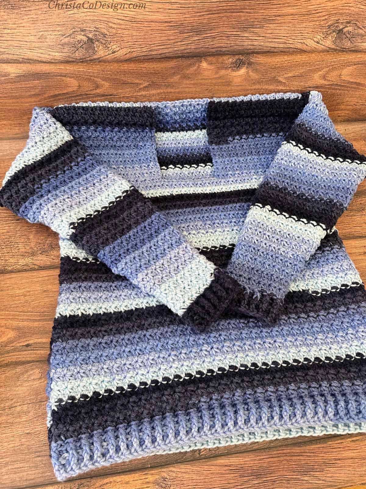 Blue striped crochet sweater seamed and ready for neck.