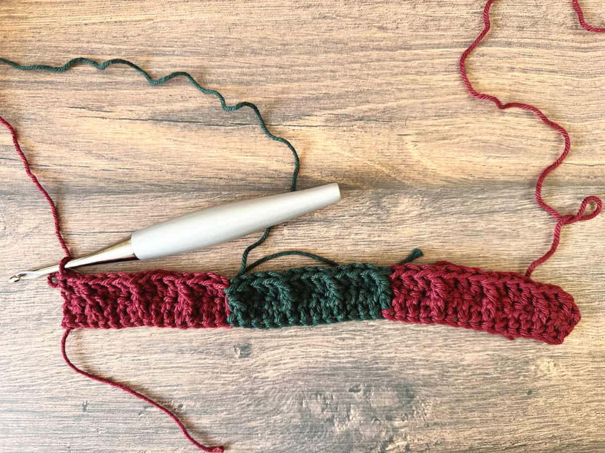 Red and green sample with yarn attached to carry up.