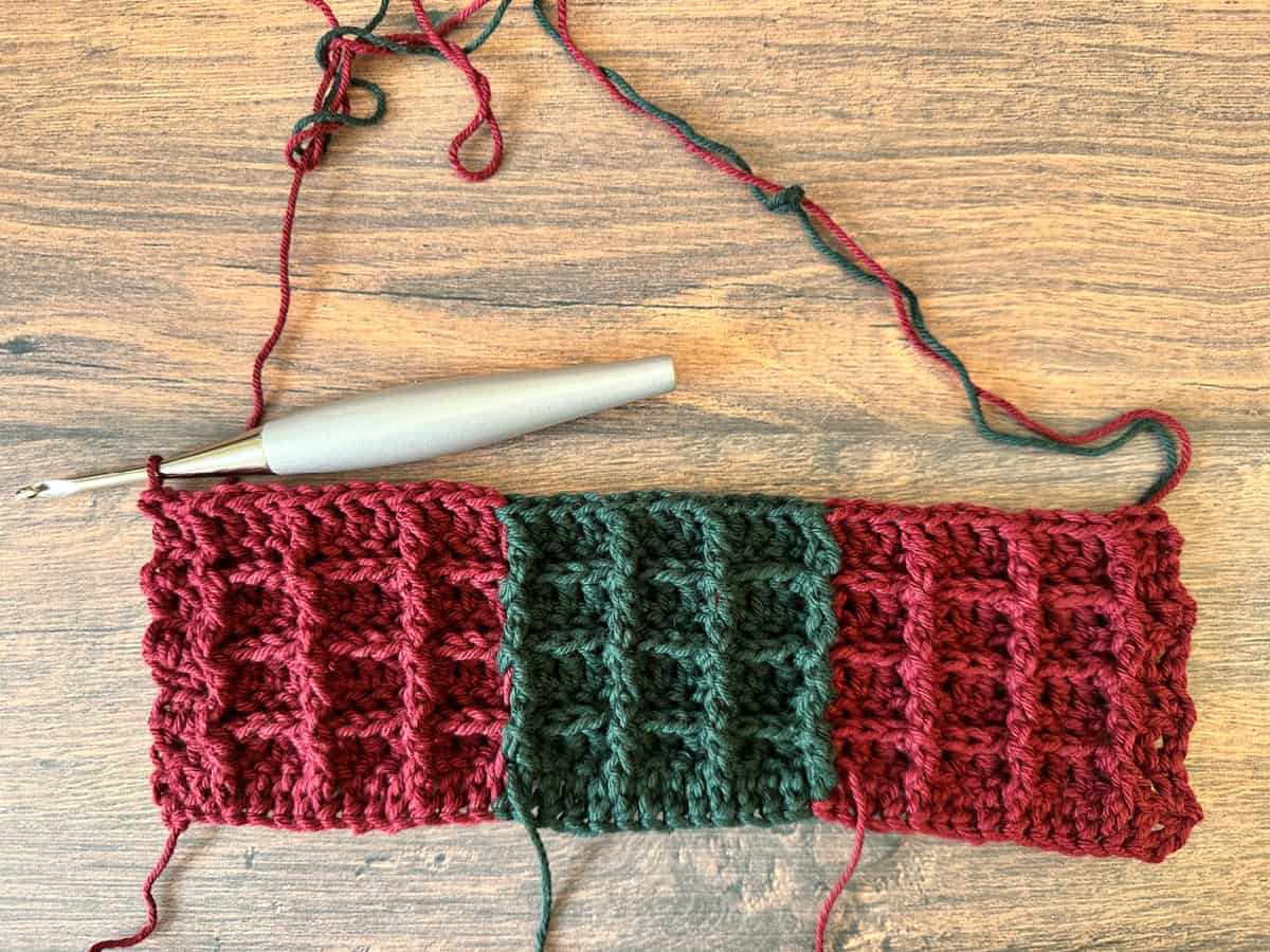 Crochet waffle stitch sample in red and green plaid.