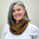 Woman smiling in knit cowl.