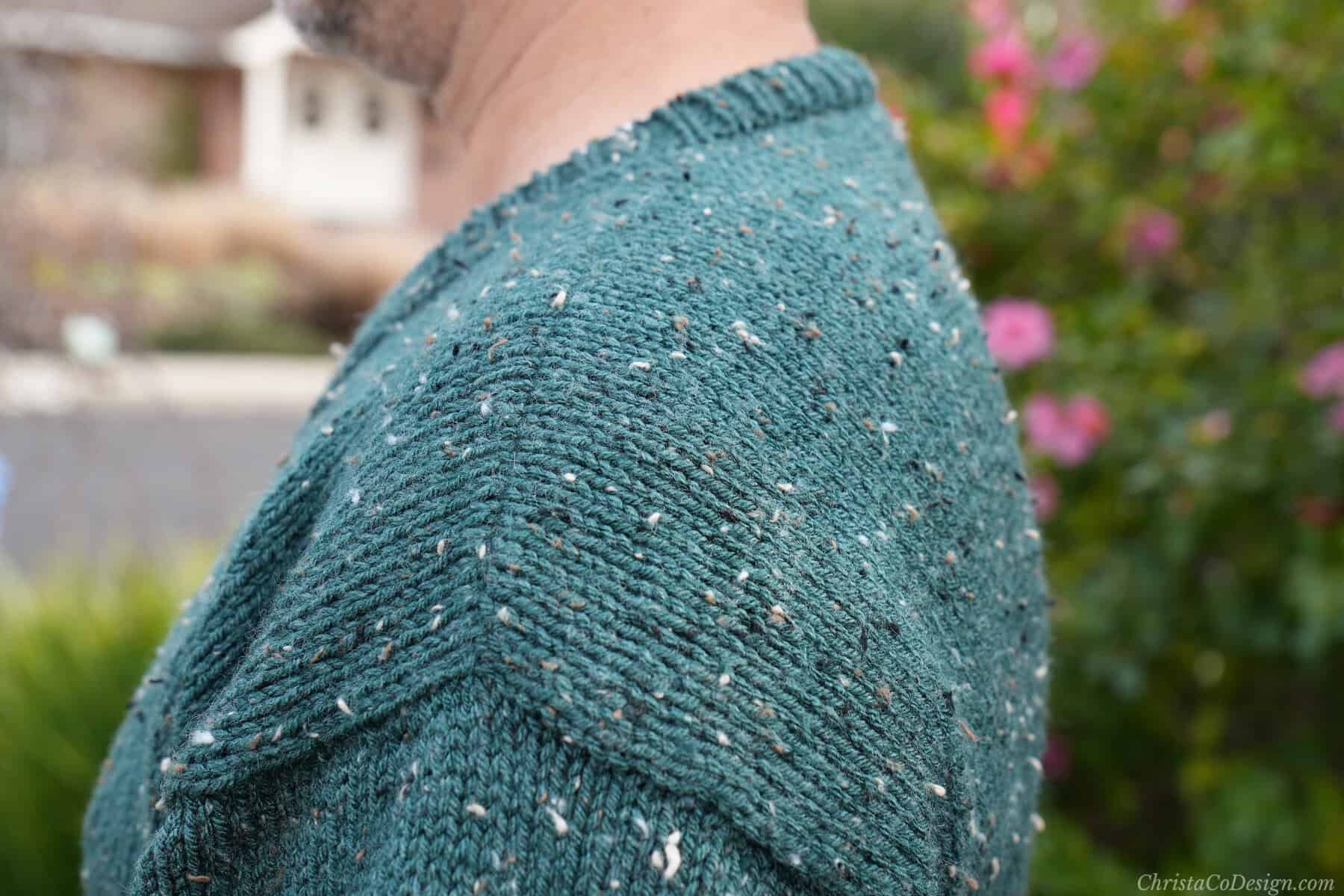 Shoulders and sleeve join of knit sweater.