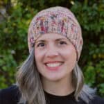 Woman smiling in crochet hat.