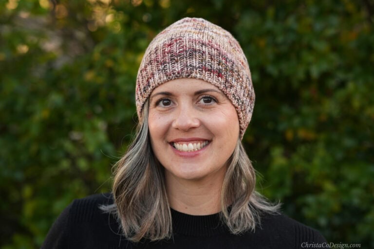 Woman smiling in fitted knit beanie.