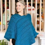 Woman looking to side in blue poncho.