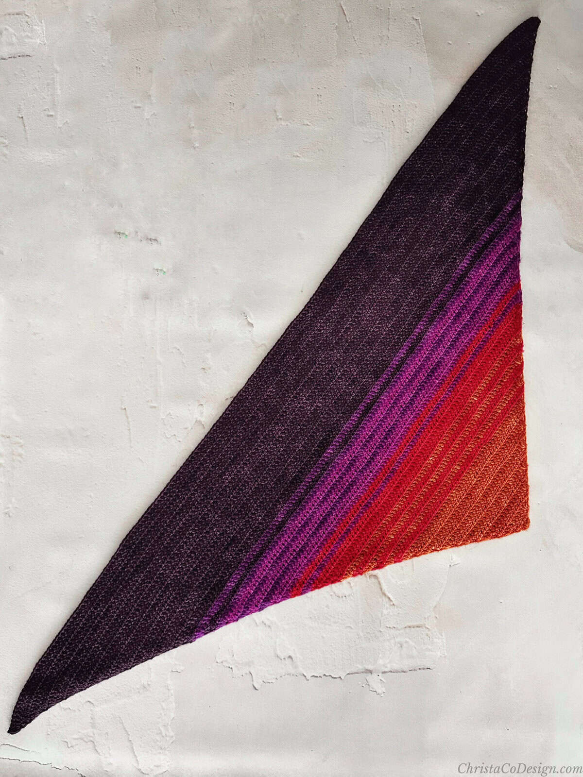 Crochet triangle scarf laid flat.