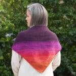 Woman with ombre triangle scarf on back.