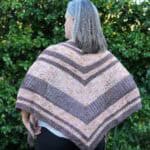Back view of crochet triangle shawl in pinks and brown.