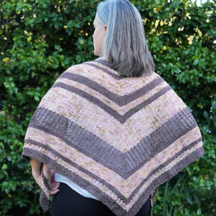 Back view of crochet triangle shawl in pinks and brown.