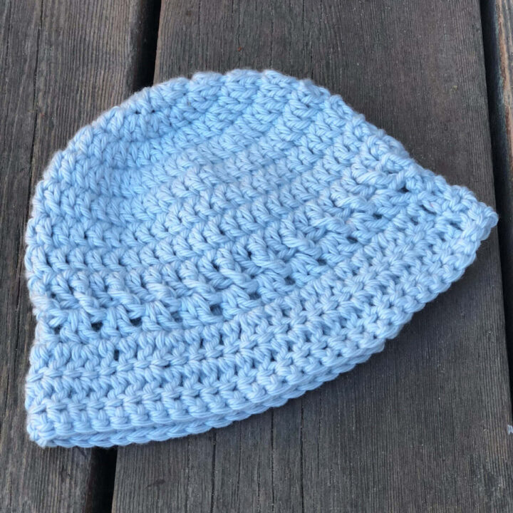 Baby size crochet bucket hat in blue.