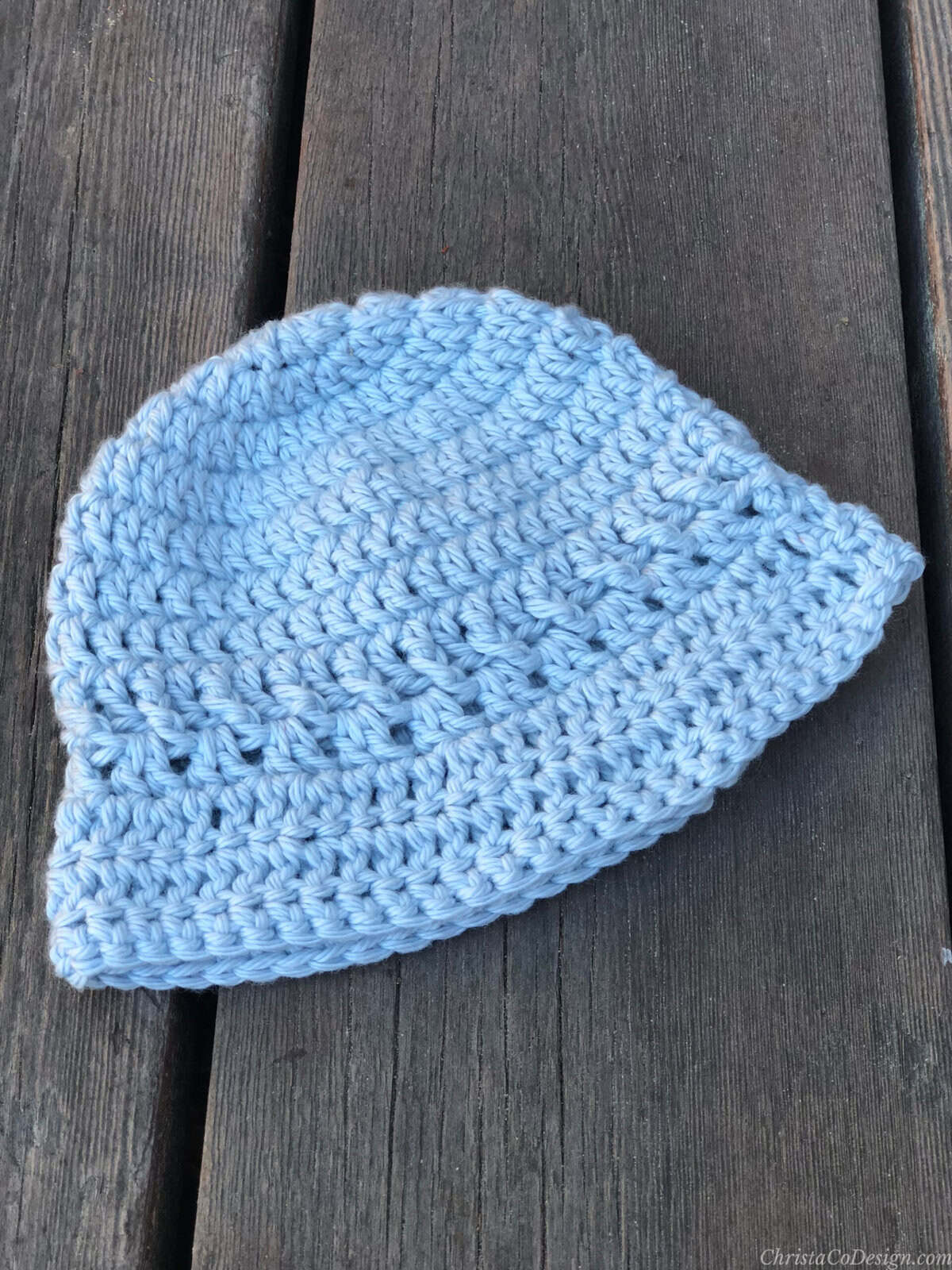 Baby size crochet bucket hat in blue.
