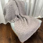 Chunky textured blanket draped on chair.