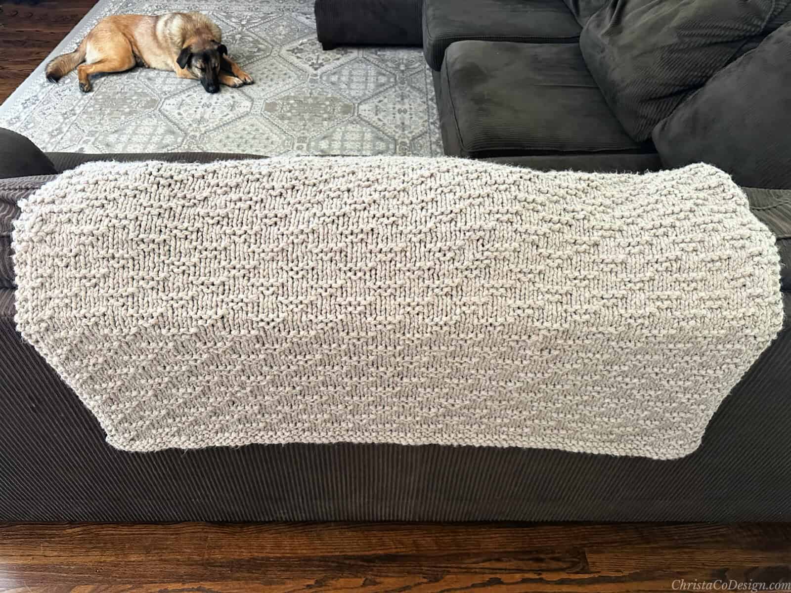 Knit blanket draped on back of couch.