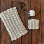 White knit dishcloth with notions.