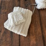 Two white knit dishcloths folded on one another.