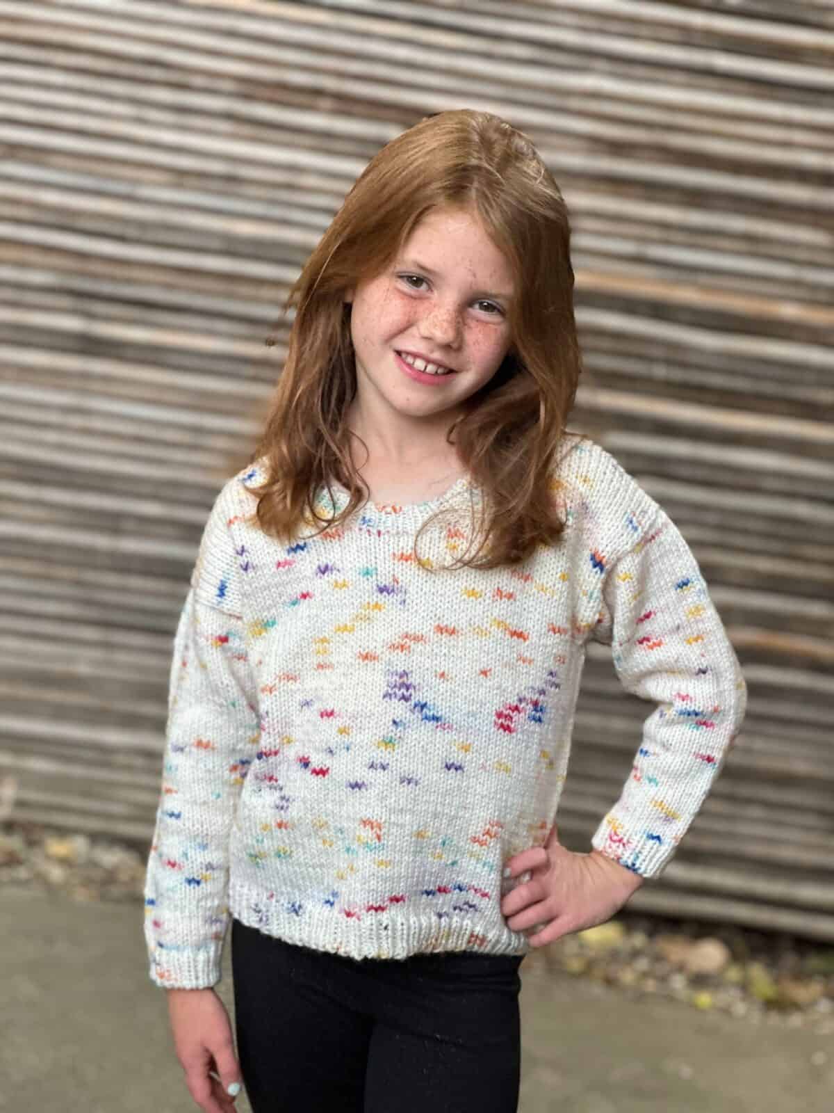 Girl in knit round neck sweater.