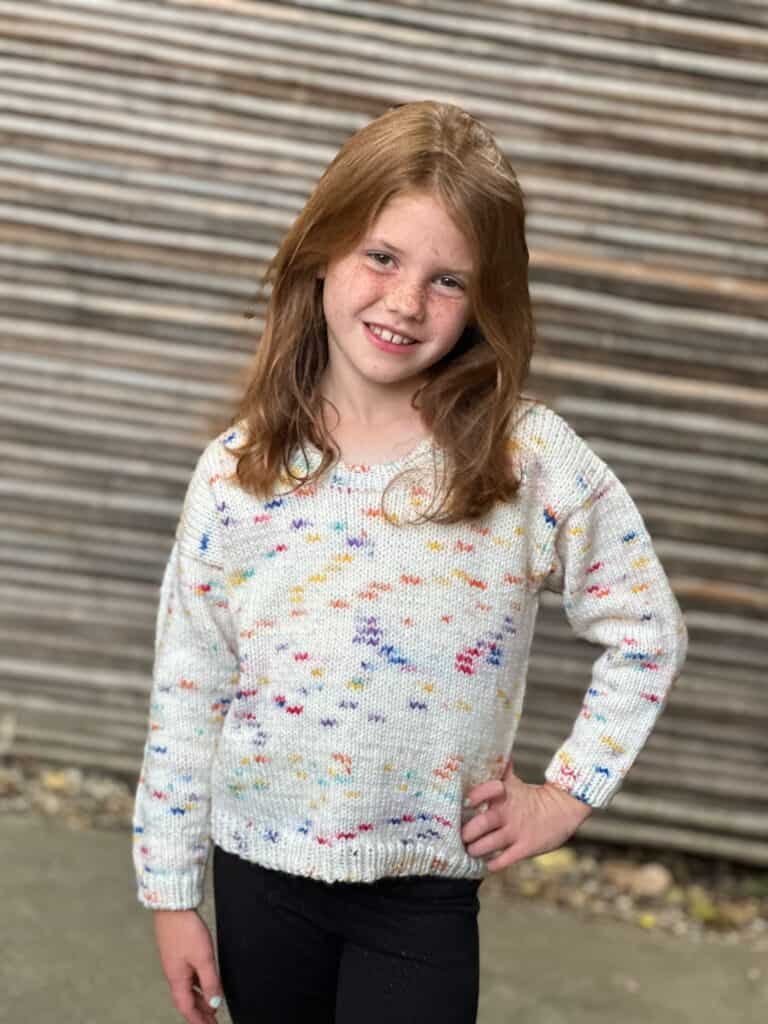 Girl in knit round neck sweater.