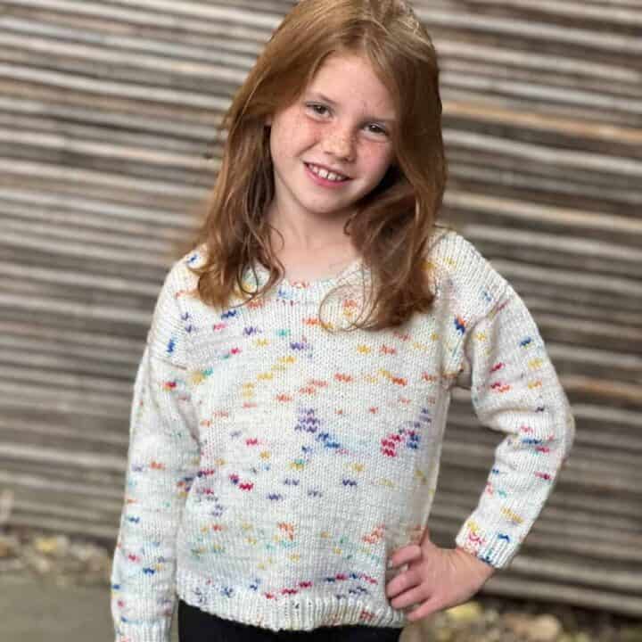 Girl in knit round neck sweater.