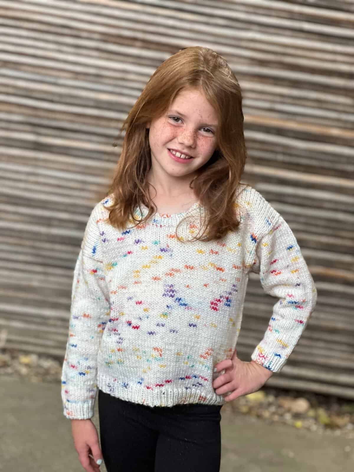 Girl in knit round neck sweater.