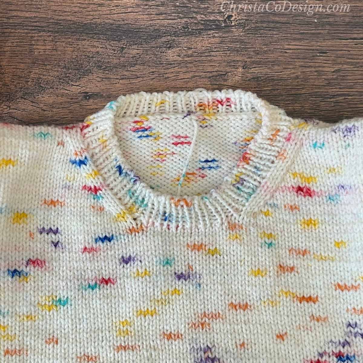 Neckline on sweater finished with 1x1 rib.