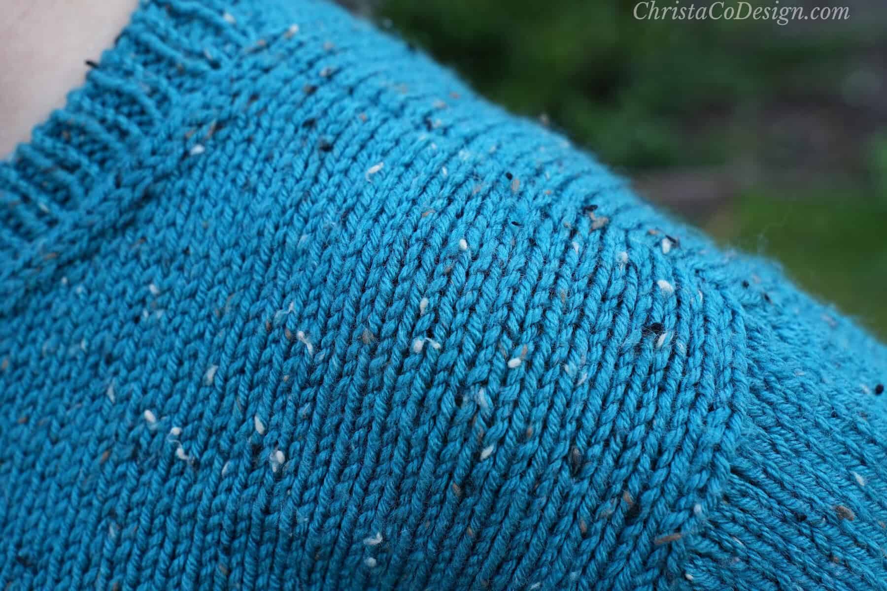 Close up of shoulder seam on knit sweater.
