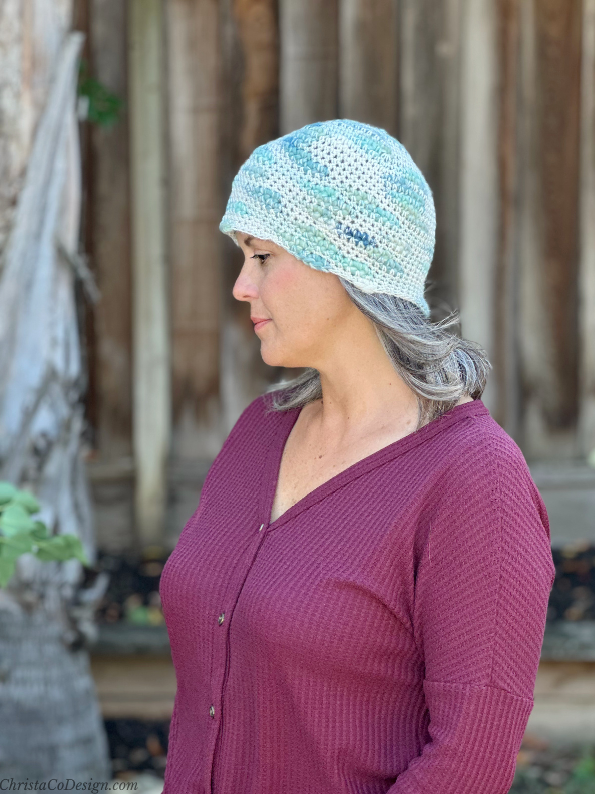 Woman turned to side in blue and white chunky beanie.
