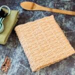 Knit towel folded next to spoons.